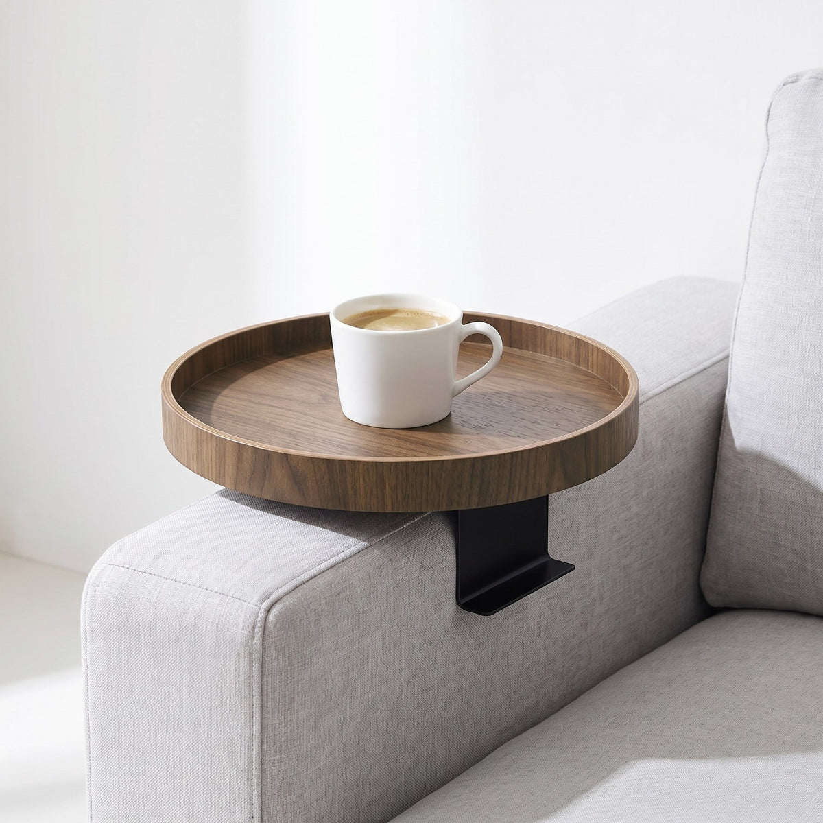 Walnut clip-on tray on a sofa arm with a mug of coffee