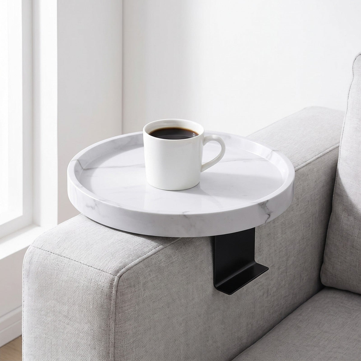 White Marble clip-on tray on a sofa arm with a mug of coffee