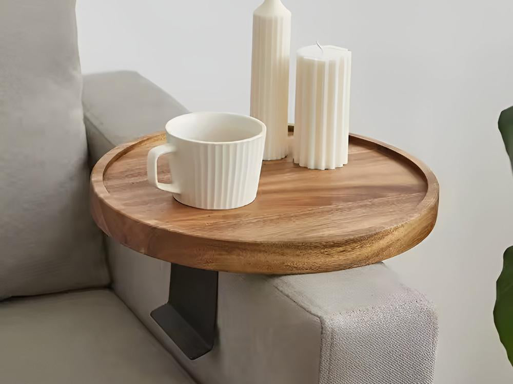 Wood sofa arm tray holding a mug and candles