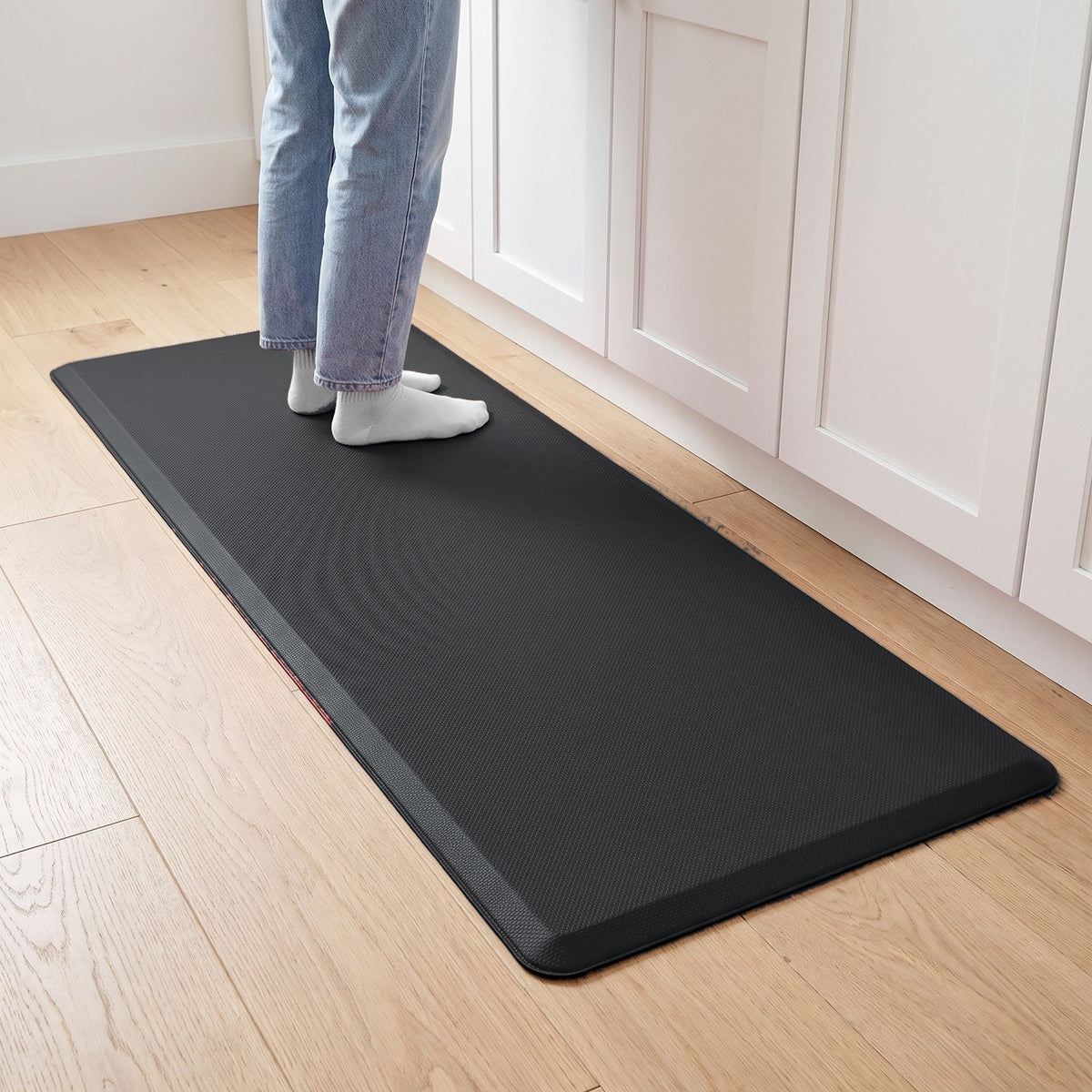 Comfort anti-fatigue kitchen mat in Black in front of kitchen cabinets