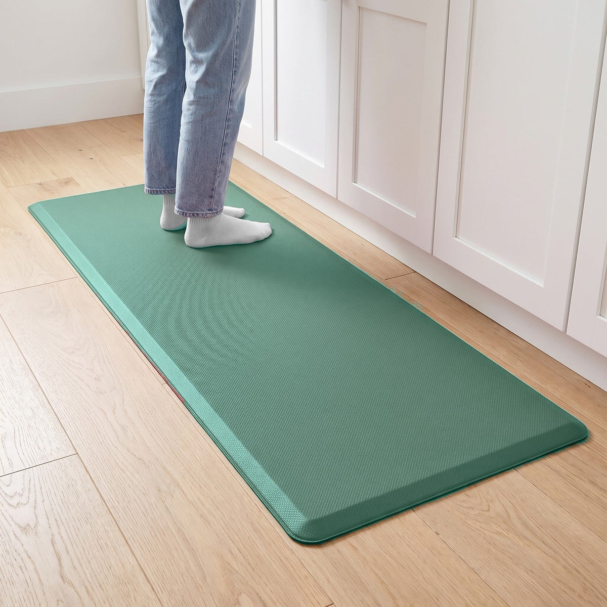 Comfort anti-fatigue kitchen mat in Green in front of kitchen cabinets