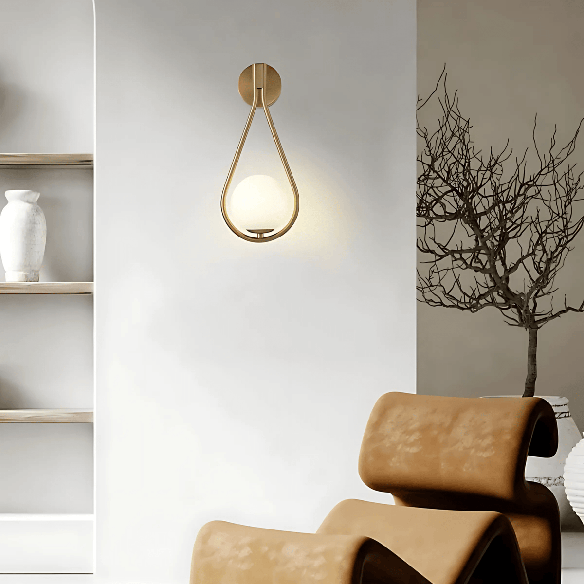 Brass teardrop wall sconce above a lounge chair in a living room