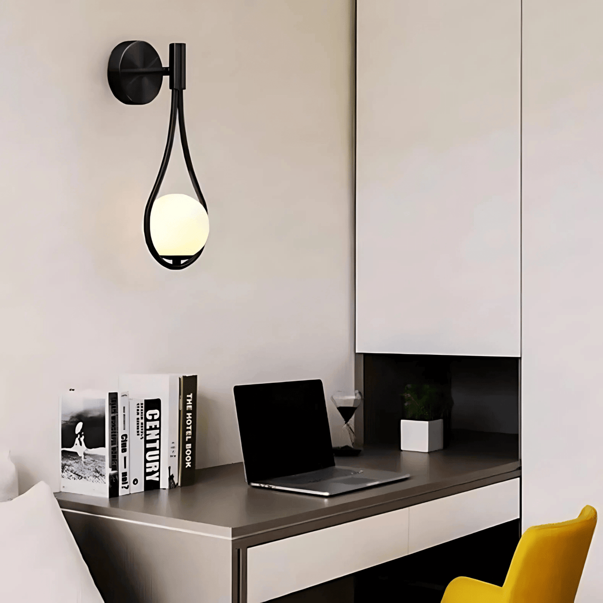 Black globe wall sconce above a desk in a home office