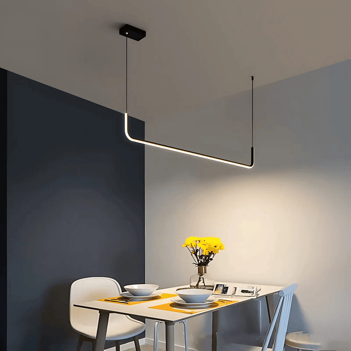 Black Dumont linear pendant light over a small dining nook
