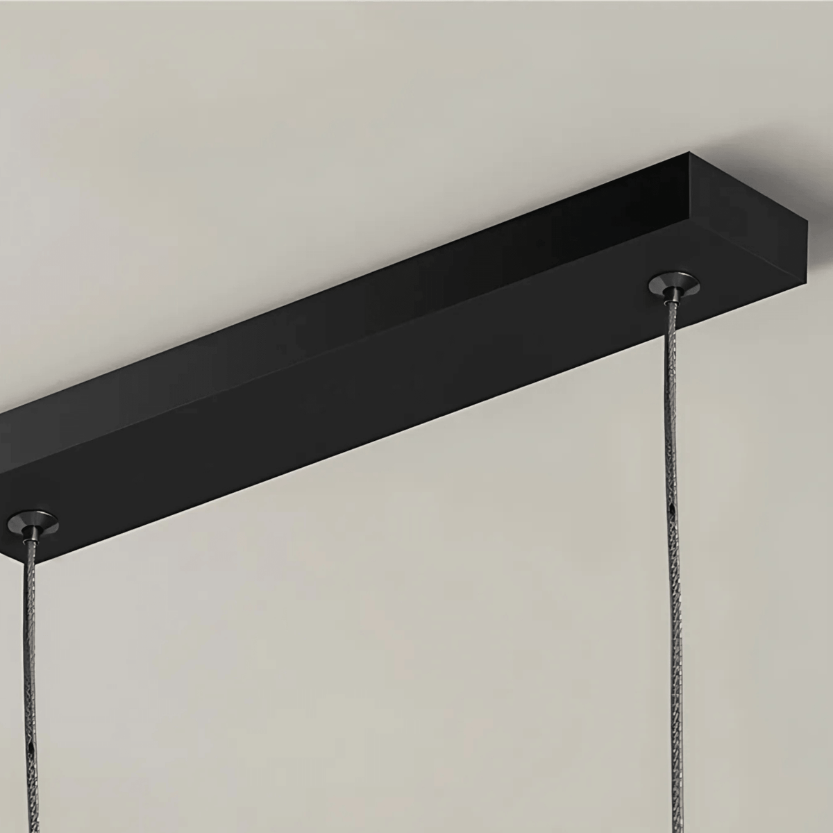 Close view of the black ceiling canopy of the Dumont pendant light