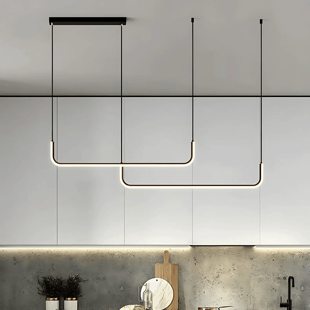 Black two bar Dumont pendant light in front of white kitchen cabinets