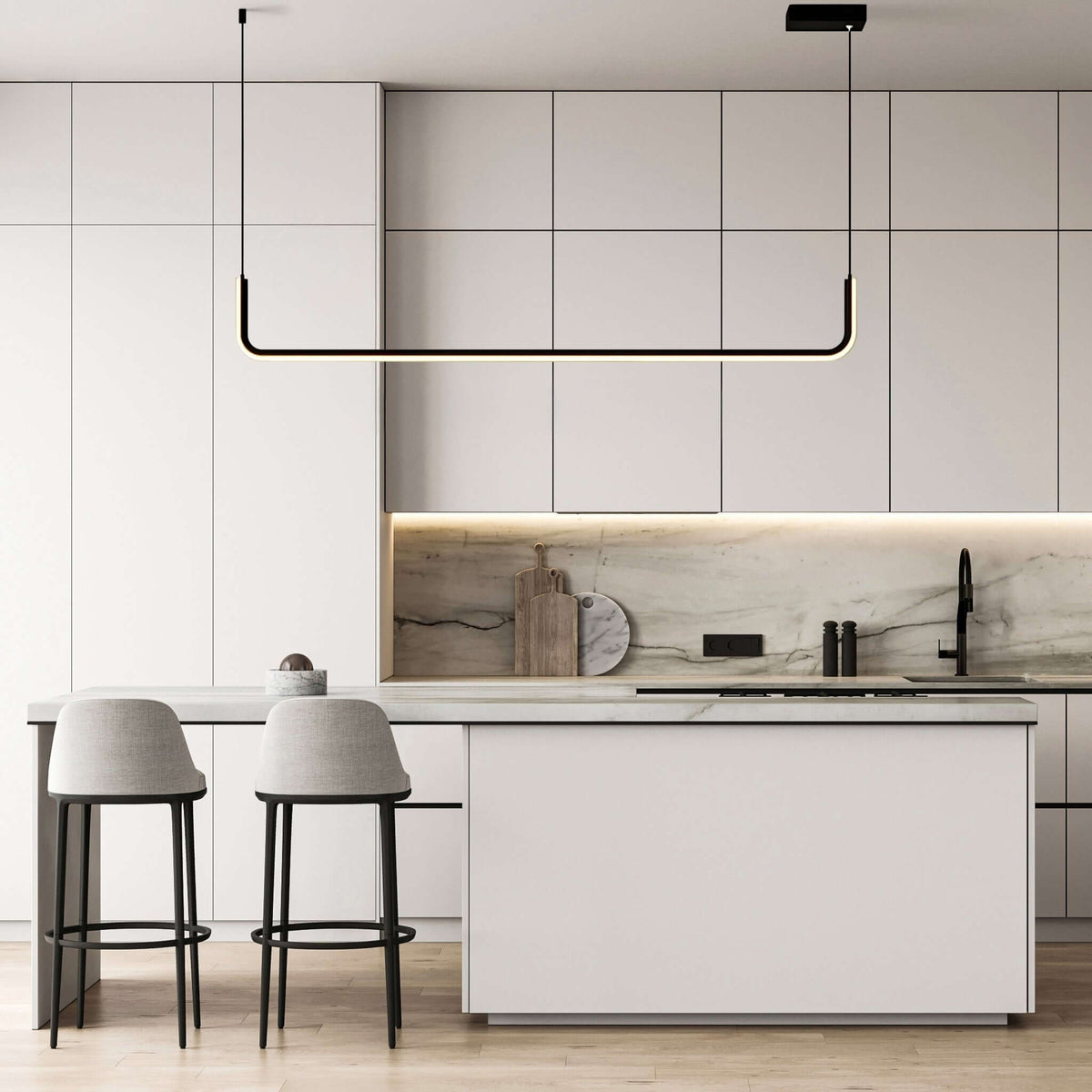 Black single bar Dumont pendant light over a white kitchen island