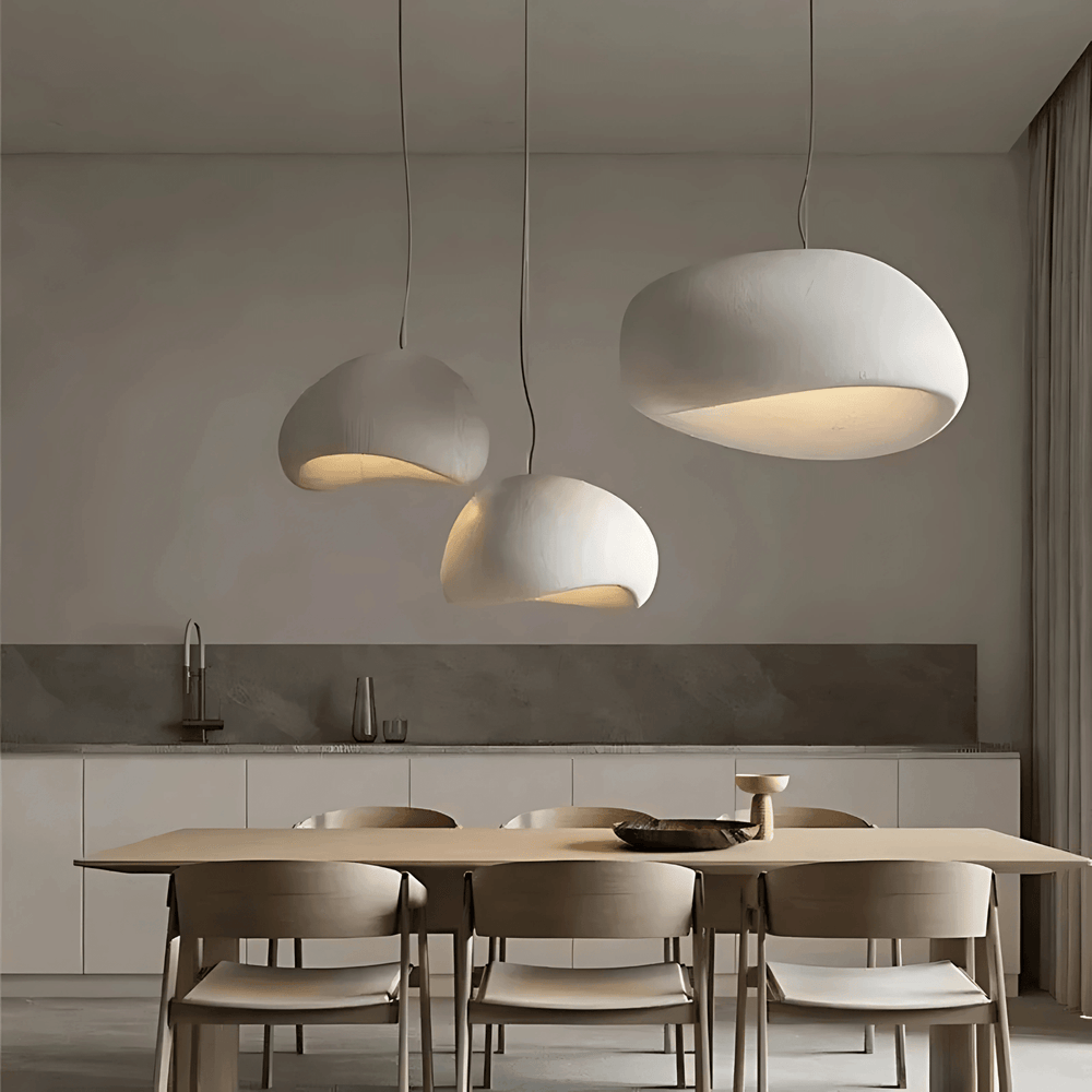 Three white Ginza pendant lights over a wooden dining table