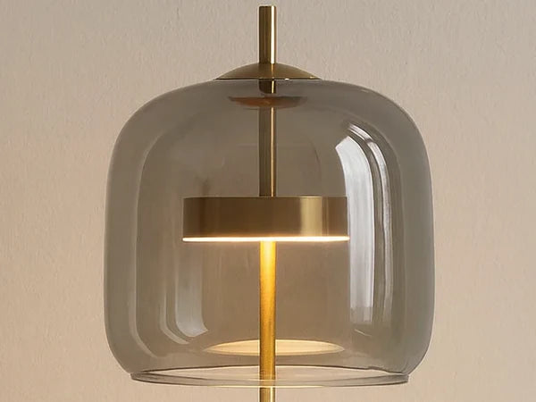 Close-up of the smoke gray glass dome with the brass LED ring inside