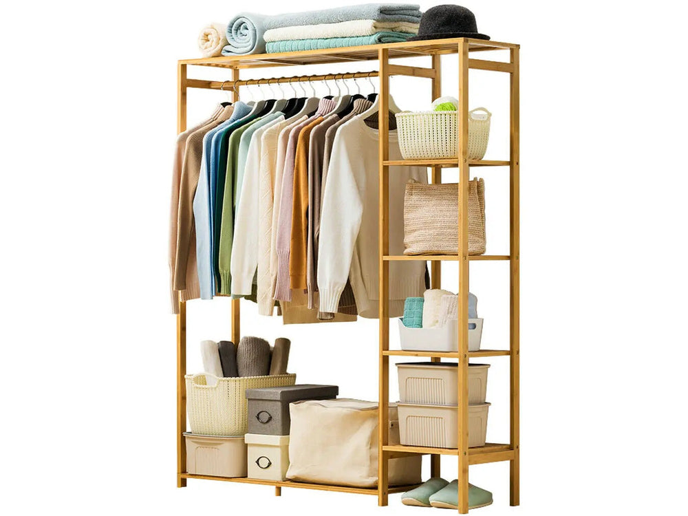 Bamboo garment rack with side shelves holding clothes and baskets, full view