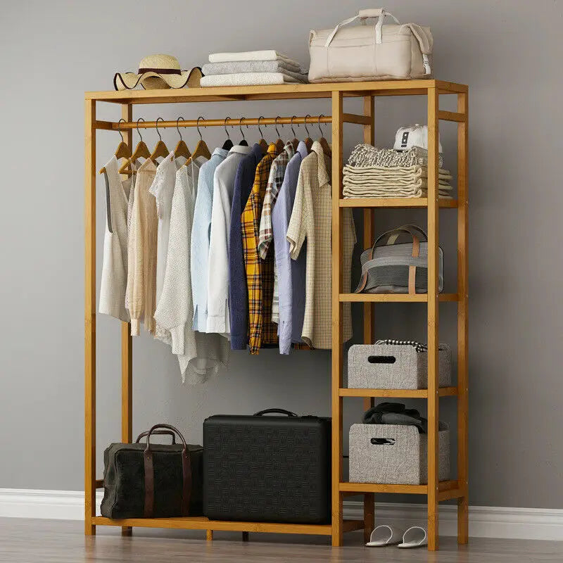 Bamboo garment rack with suitcases on the bottom shelf and bags on the side shelves