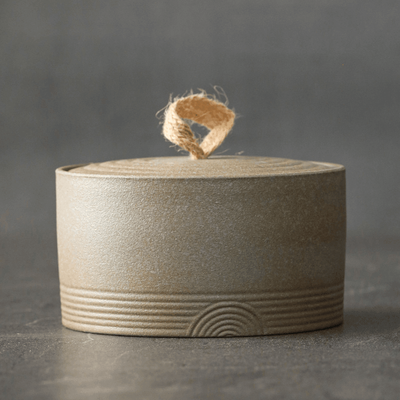 Handmade Japanese ceramic storage jar with hemp rope handle detail shot of the lid and rim