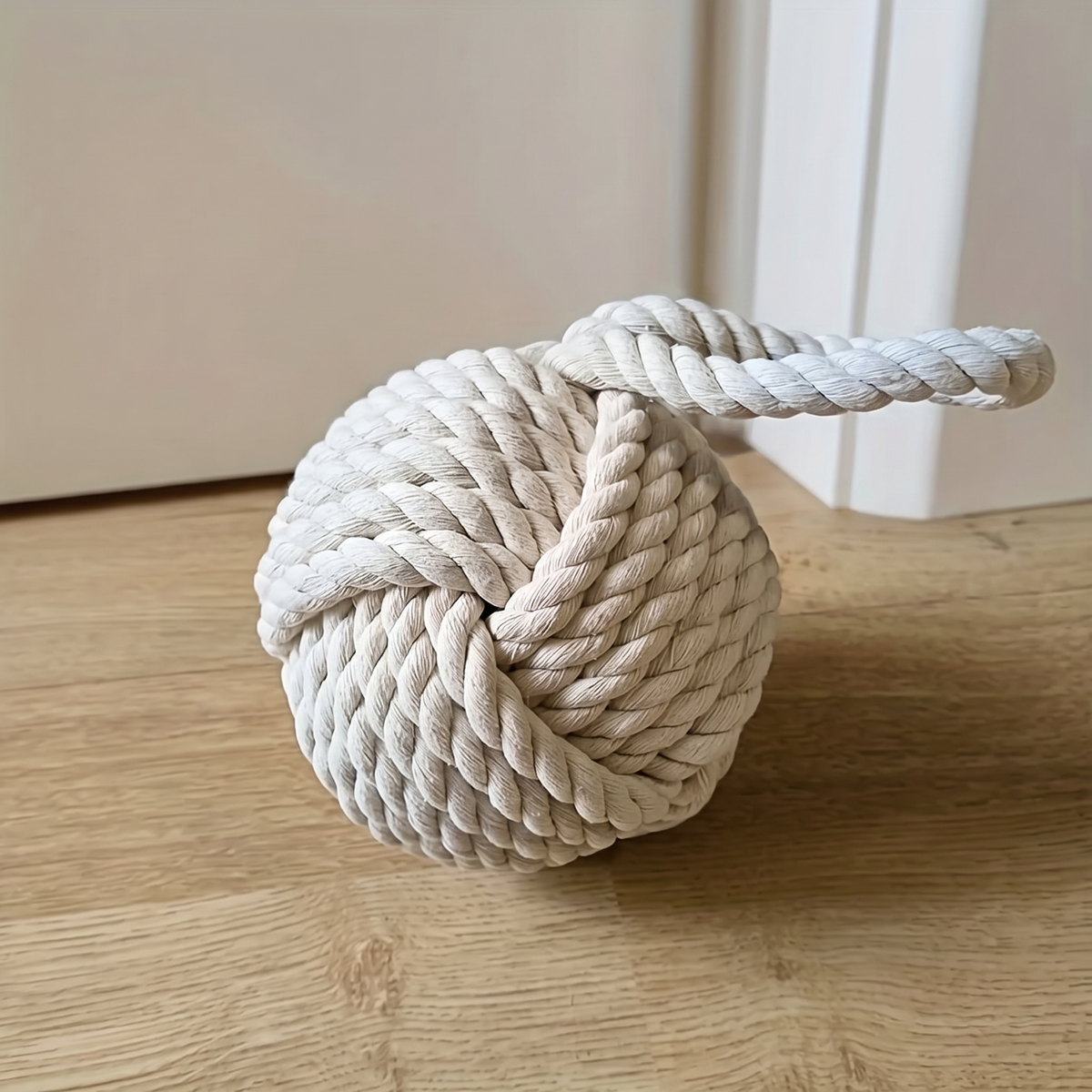 White rope ball door stop tied as one large knot