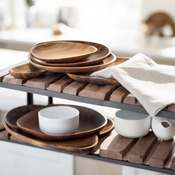 Small teardrop acacia serving tray with olives on a linen table