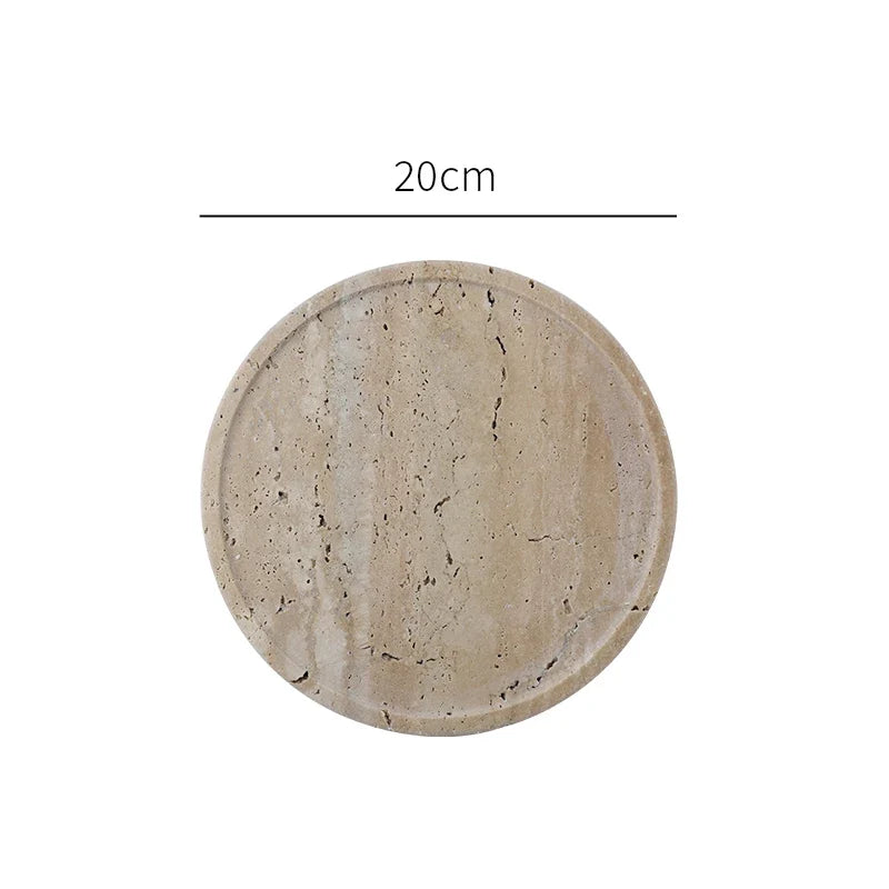 Large round travertine tray seen from above on white