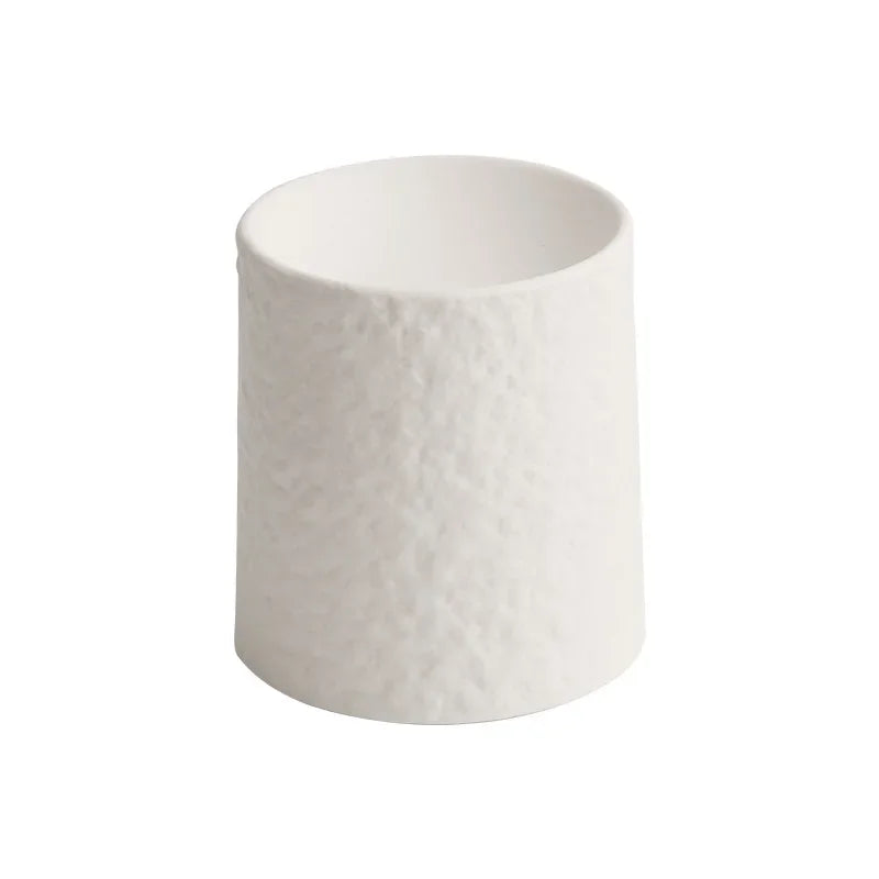 Plain tall white textured ceramic pedestal dish on white