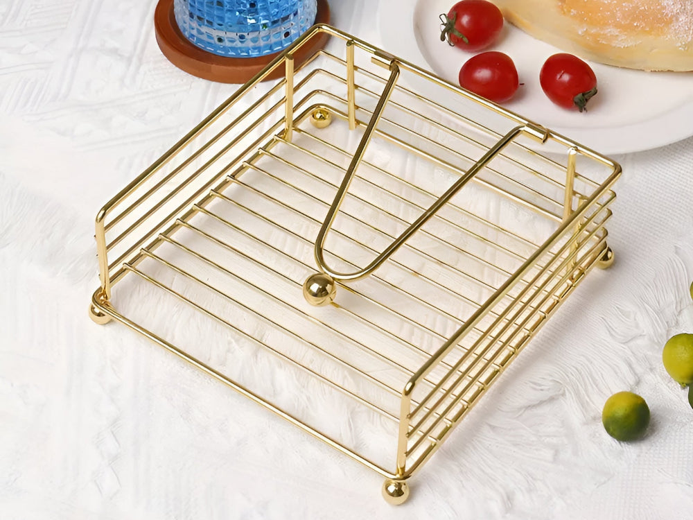 Gold wire napkin holder on a breakfast table
