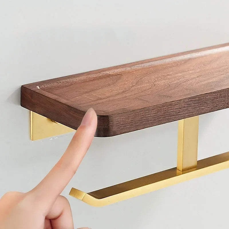 Finger on the recessed edge of the walnut shelf with brass tone bar below