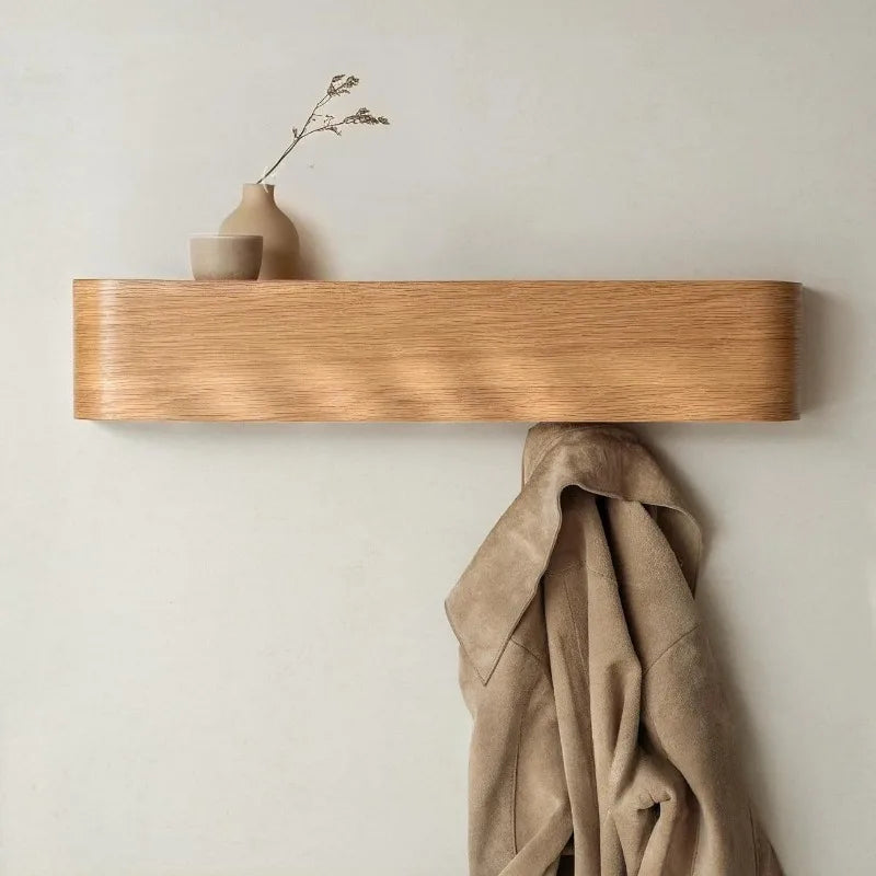 Close view of the natural curved wall shelf with a coat on the hook