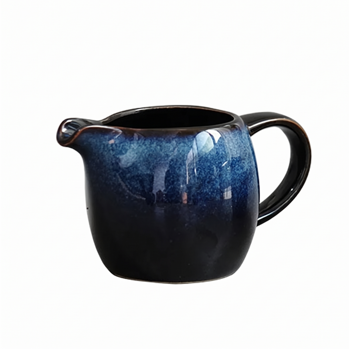 Blue kiln glazed creamer jug with a dark handle on white