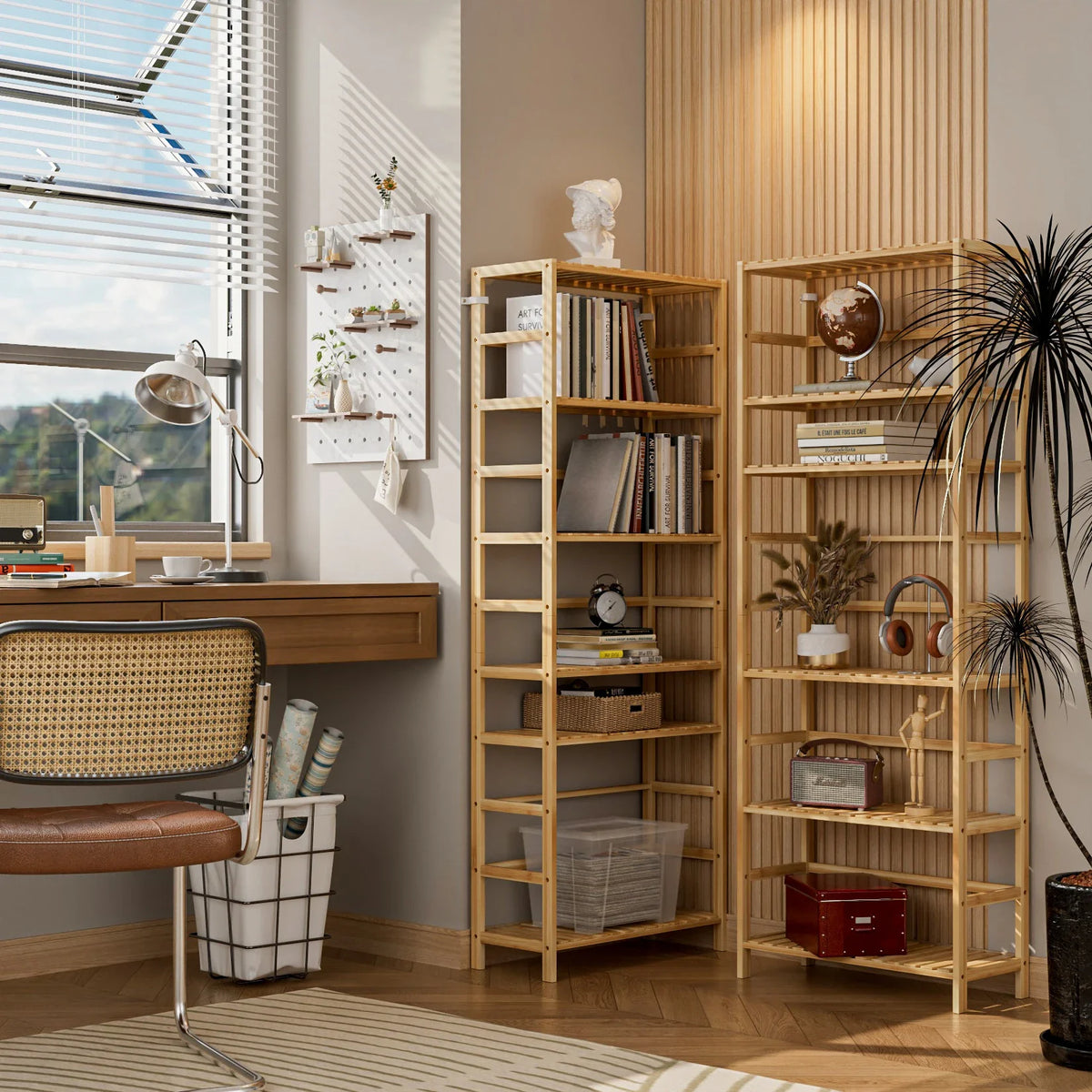 Two bamboo shelving units with books and plants in a home office