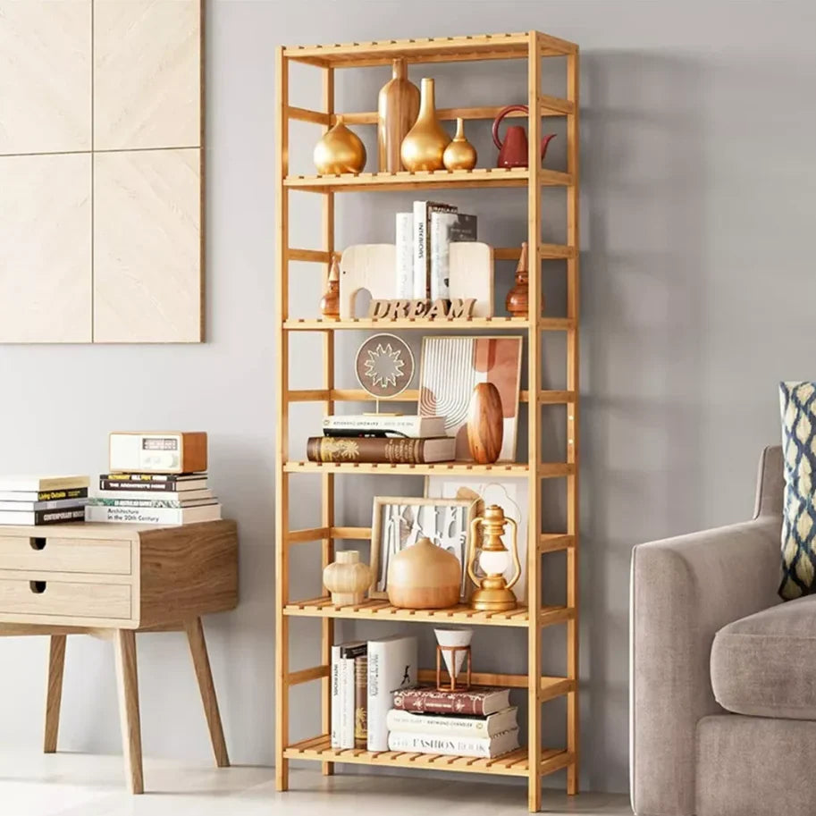 Six tier bamboo bookshelf styled with books and ceramics in a living room