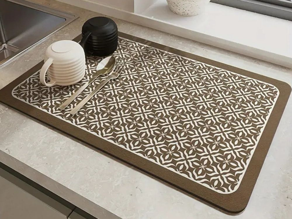 Brown and beige patterned dish drying mat on a kitchen counter beside the sink