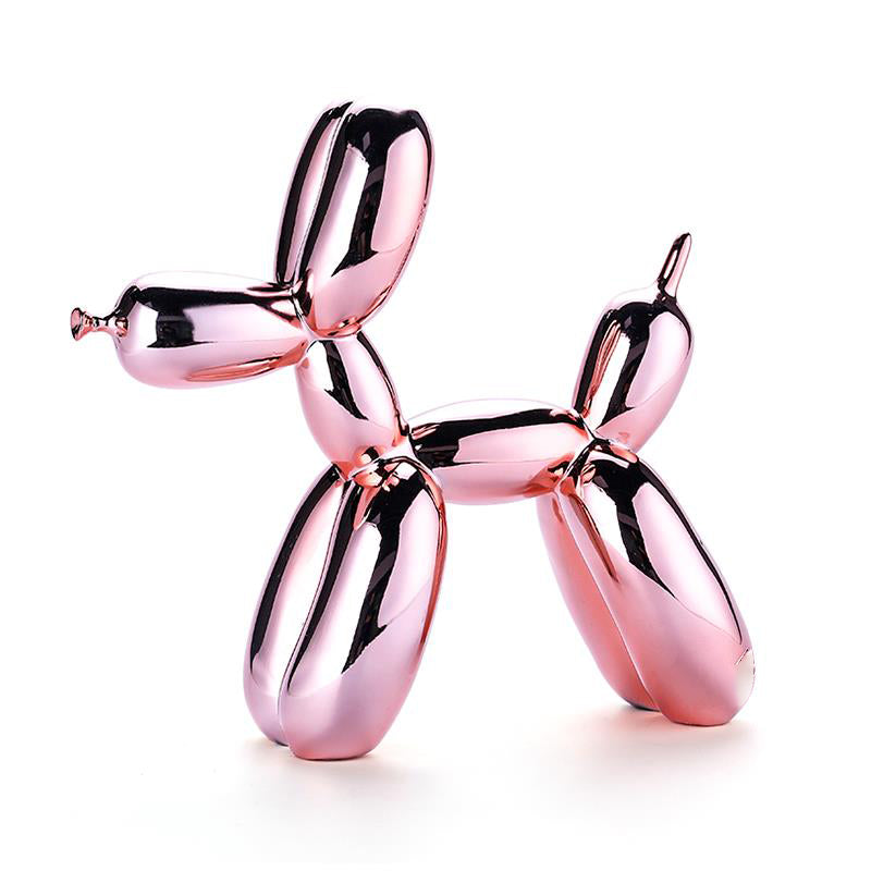 Pink glossy balloon dog sculpture on a white background