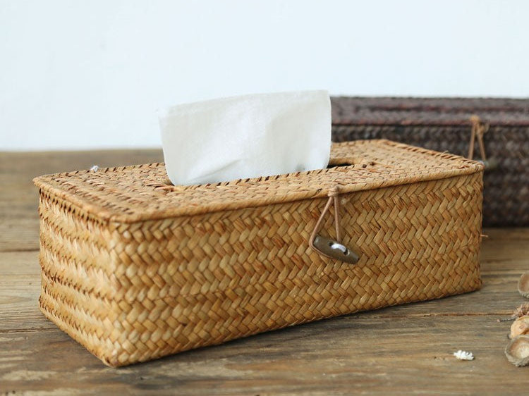 Rattan tissue box cover with a tissue on a wooden table