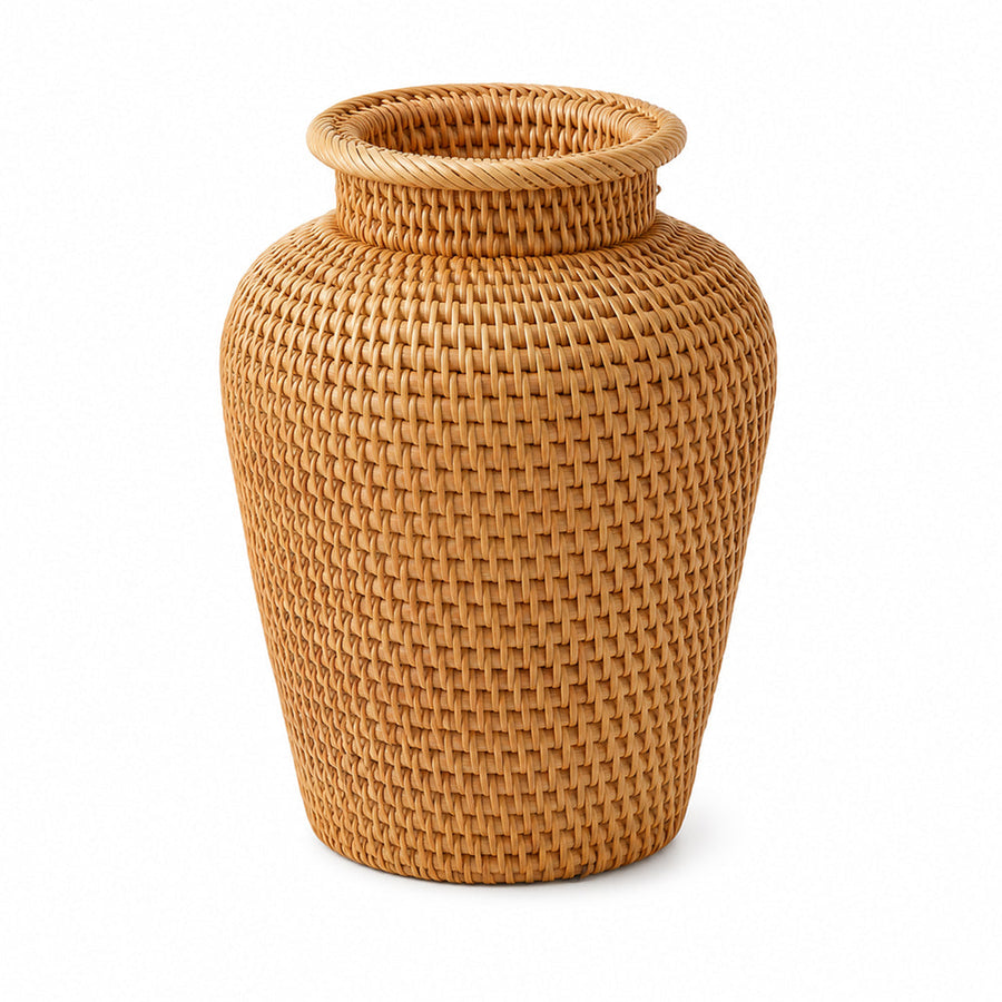 Handwoven rattan vase in a warm natural tone on a shelf
