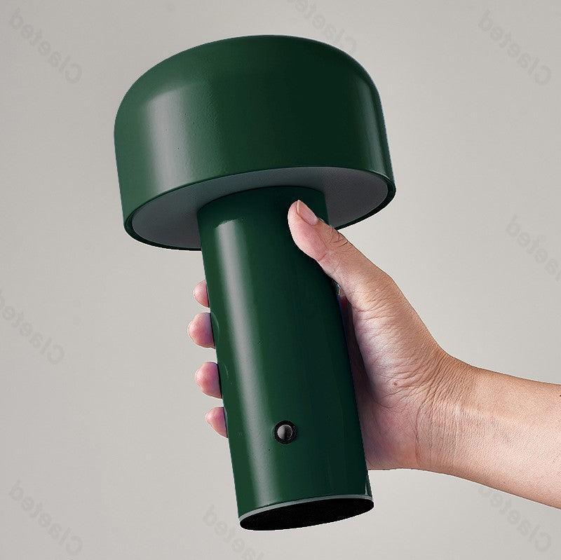 Retro Italian mushroom portable table lamp shown against a warm plaster wall