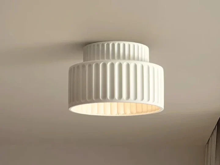 White ribbed resin flush mount ceiling light with two tiers, lit from inside