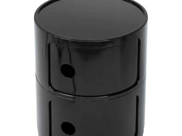 Close up of the glossy black storage unit with its sliding door and finger hole