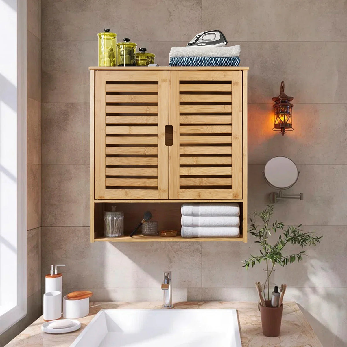 Louvered bamboo wall cabinet on a stone bathroom wall with folded towels below