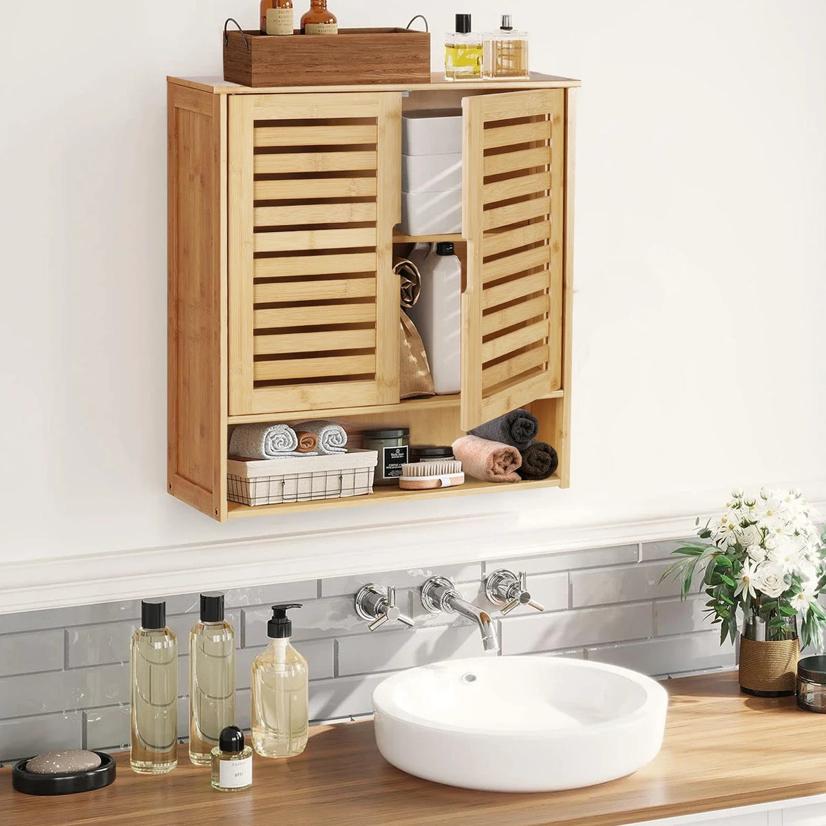 Bamboo wall cabinet with the doors open showing toiletries above a basin