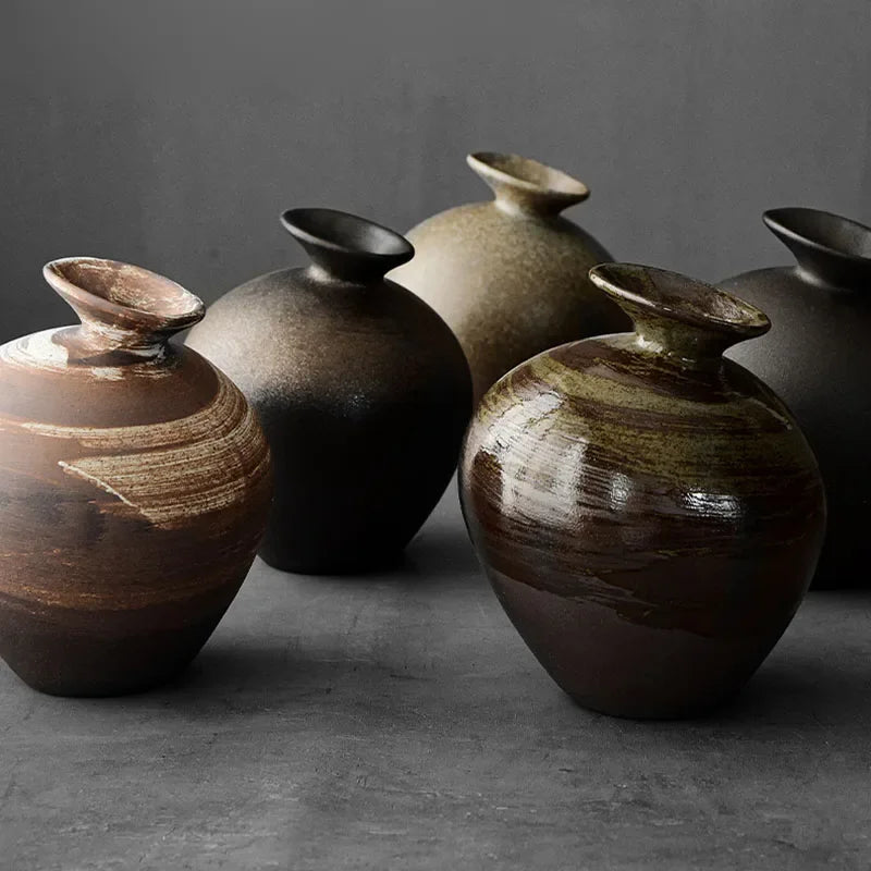 Group of ceramic jar bud vases in brown, black and olive glazes