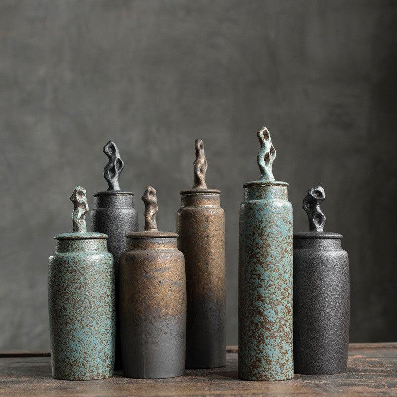 Handmade stoneware tea caddy with airtight ceramic lid on a light styled tabletop