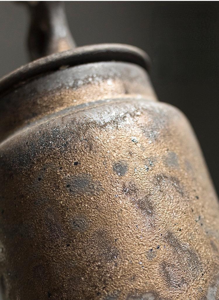 Handmade stoneware tea caddy with airtight ceramic lid held in one hand to show the scale