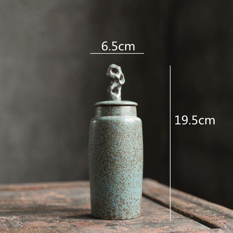 Handmade stoneware tea caddy with airtight ceramic lid angled view showing the full silhouette