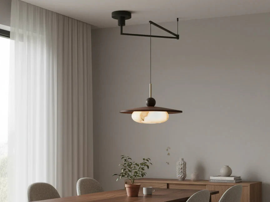 Swing arm pendant light with a walnut shade hanging over a dining table