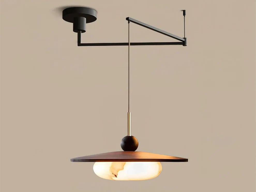 Swing arm pendant light with matte black arm, walnut shade and lit diffuser