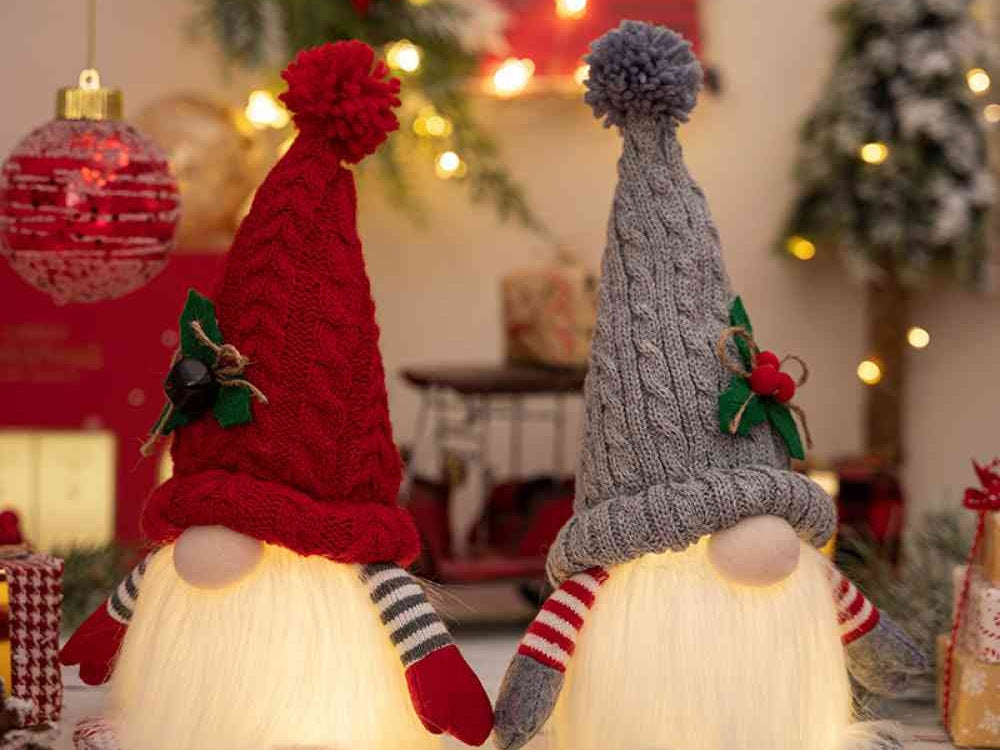Red and gray Christmas gnomes glowing with the light on