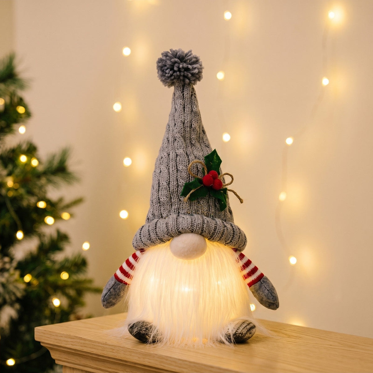 Gray light-up Christmas gnome with the beard glowing on a mantel