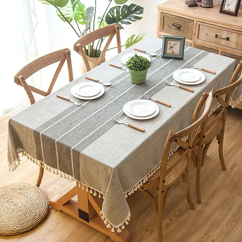 Blue gray striped cotton linen tablecloth on a wooden dining table