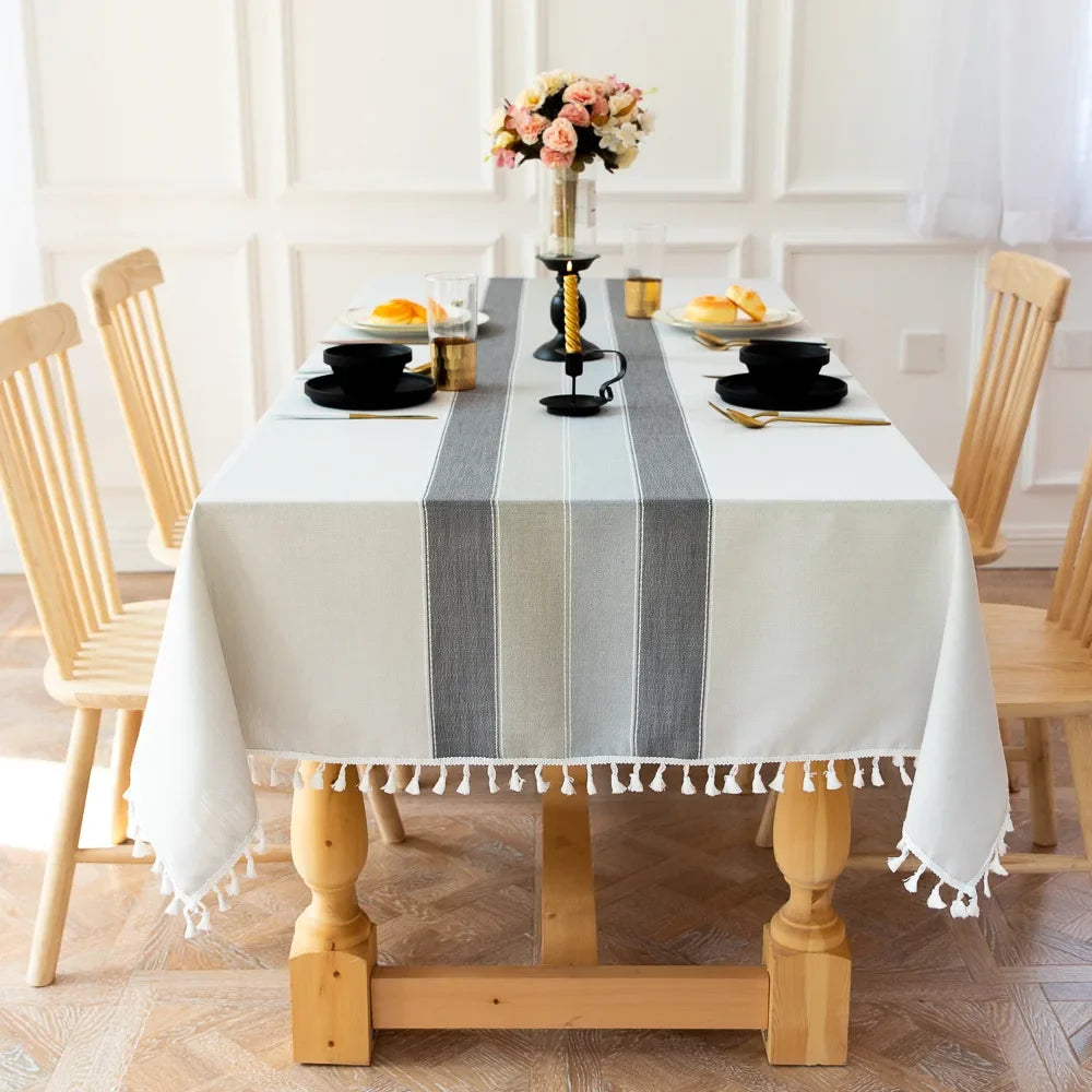 Dove gray tablecloth with a wide stripe band and tassel trim